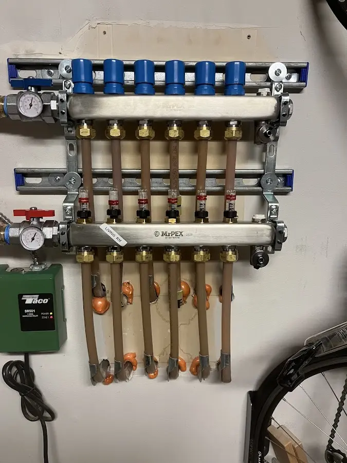 Plumber performing Water Heater Repair at a residential property in Genesee